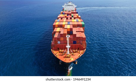 Aerial Drone Top View Of Fully Loaded Container Ship Cruising Open Ocean Sea For Logistics Import Export, Shipping Or Transportation