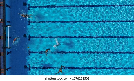 Aerial drone top view photo of people competing in waterpolo in turquoise water pool