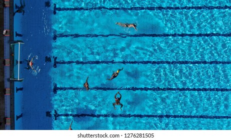 Aerial drone top view photo of people competing in waterpolo in turquoise water pool
