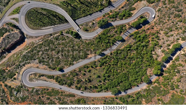 Aerial drone top view photo of snake road built in
steep mountain slope
