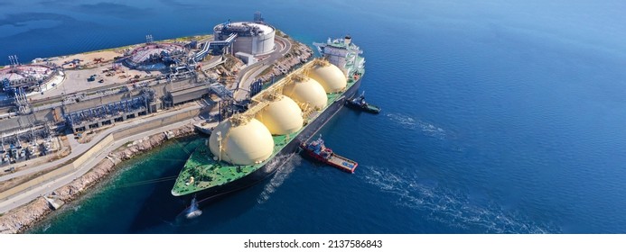Aerial drone ultra wide panoramic photo with copy space of LNG (Liquified Natural Gas) tanker anchored in small gas terminal island with tanks for storage - Shutterstock ID 2137586843