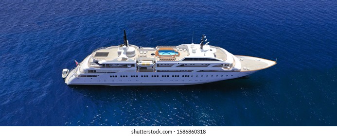 Aerial Drone Ultra Wide Photo Of Luxury Mega Yacht With Wooden Deck Docked In Aegean Island Destination Deep Blue Open Sea