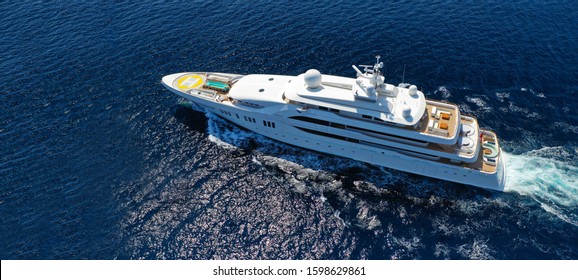 Aerial Drone Ultra Wide Photo Of Luxury Mega Yacht With Wooden Deck Cruising Aegean Deep Blue Sea