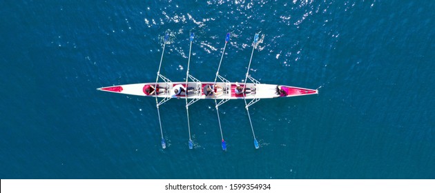 Aerial drone ultra wide photo of sport canoe with young team of athletes practising in deep blue open ocean sea - Shutterstock ID 1599354934