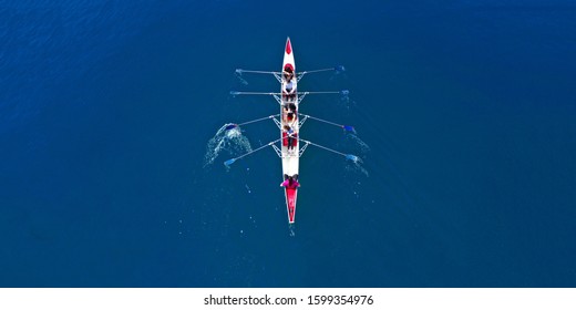 Aerial Drone Ultra Wide Photo Of Sport Canoe With Young Team Of Athletes Practising In Deep Blue Open Ocean Sea