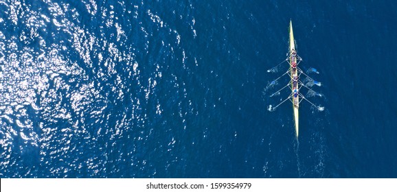 Aerial drone ultra wide photo of sport canoe with young team of athletes practising in deep blue open ocean sea - Shutterstock ID 1599354979