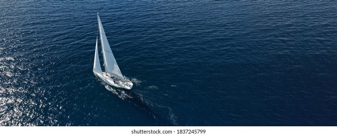 Aerial Drone Ultra Wide Photo Of Beautiful Sailboat Cruising Deep Blue Open Ocean Mediterranean Sea