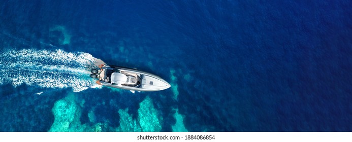 Aerial Drone Ultra Wide Photo Of Inflatable Rib Power Boat Cruising In High Speed In Tropical Exotic Bay With Coral Reef And Deep Blue Sea