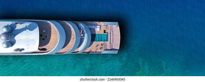 Aerial drone ultra wide photo of latest technology modern silver mega yacht and the only hybrid one called "Savannah" yacht anchored near exotic destination island - Shutterstock ID 2146965045