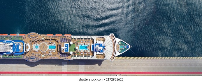 Aerial drone ultra wide photo with copy space of huge cruise liner anchored in Mediterranean port with top deck pool facilities - Powered by Shutterstock