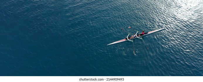 Aerial drone ultra wide top down panoramic photo with copy space of sport canoe operated by young woman in deep blue calm sea waters - Powered by Shutterstock