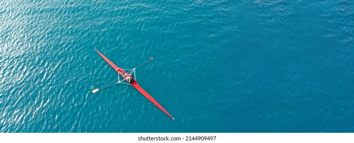 Aerial drone ultra wide top down panoramic photo with copy space of sport canoe operated by young woman in deep blue calm sea waters - Shutterstock ID 2144909497