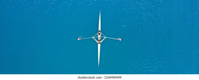 Aerial drone ultra wide top down panoramic photo with copy space of sport canoe operated by young woman in deep blue calm sea waters - Shutterstock ID 2144909499