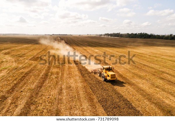 Aerial drone video of the harvesting machine in\
the field.