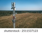 Aerial drone view of 5G telecommunication tower. GSM and radio telecommunication tower. Cell phone tower. Base transceiver station. Wireless communication antenna transmitter.