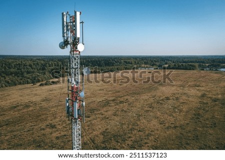 Aerial drone view of 5G telecommunication tower. GSM and radio telecommunication tower. Cell phone tower. Base transceiver station. Wireless communication antenna transmitter.