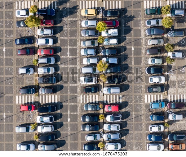 Aerial drone view above\
cars at parking