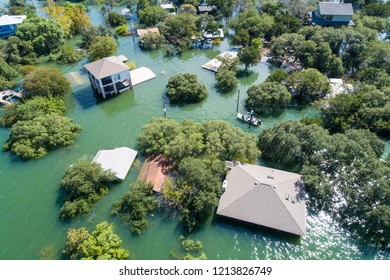 Aerial drone view above a natural disaster. Flooded homes with water up to the roof tops massive flooding all along the Colorado River with search and rescue out looking for survivors