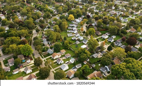 Aerial Drone View Of American Suburban Neighborhood At Daytime. Establishing Shot Of America's  Suburb. Residential Single Family Houses Pattern