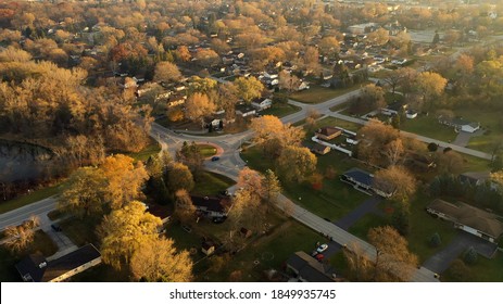 Aerial drone view of American suburban neighborhood. Establishing shot of America's  suburb, street. Residential single family houses. Autumn Winter season