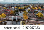Aerial drone view Amsterdam autumn cityscape narrow old houses, canals, boats bird