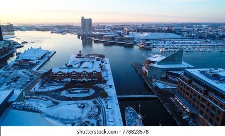 An Aerial Drone View Of Baltimore, Maryland In The Snow At Sunrise On A Cold December Morning.