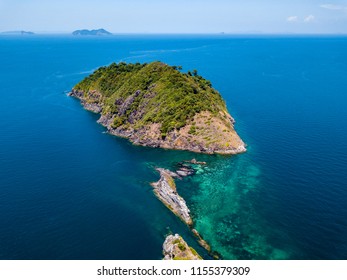 Aerial Drone View Of A Beautiful Remote Tropical Island Surrounded By Coral Reef