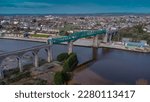 Aerial drone view of Boyne viaduct in drogheda spanning over river Boyne in early evening hours. Beautiful pucture of a green metal viaduct and stone arches.