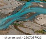 Aerial Drone View of braided river with glacial meltwater blue in New Zealand.