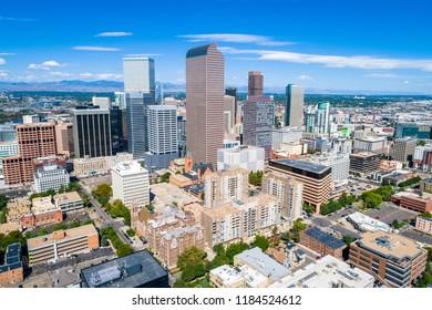Aerial drone view Center of Skyline Cityscape of Denver , Colorado , USA towers and skyscrapers rise with Rocky Mountains across horizon in background