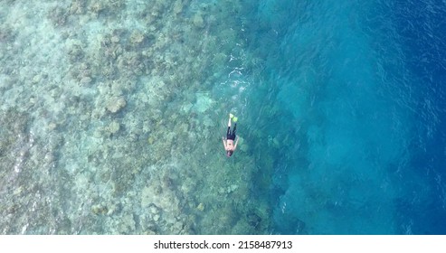 An Aerial Drone View Of The Clear Blue Water Of The Ocean In Rasdhoo Island, The Maldives