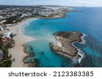 Aerial drone view of the coastline of empty beach in winter. Summer holidays. Nissi beach bay Ayia Napa, Cyprus