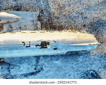 Aerial drone view of crashed plane on frozen Solheimasandur beach in winter, Iceland. Detail overhead shot - Powered by Shutterstock