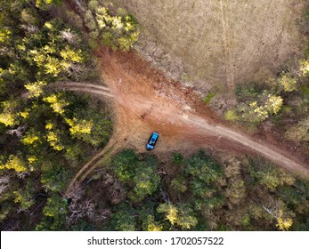 Aerial Drone View Of Crossroad. High Above Rural Road. Top Over Path Way Route. Crossing Country Road Overhead. Winding Roadway Pathway In Wilderness. Parked Car And People.