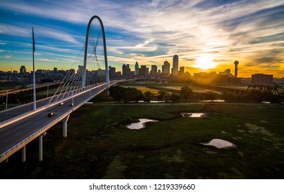 Aerial Drone View Of Dallas , Texas Skyline Cityscape Spots Of Ponds Along Trinity River With Sun Rising Beyond The Downtown Skyscrapers