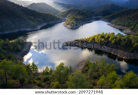 Aerial drone view of a dam full of water in the forest. Lefkara water reservoir Larnaca Cyprus
