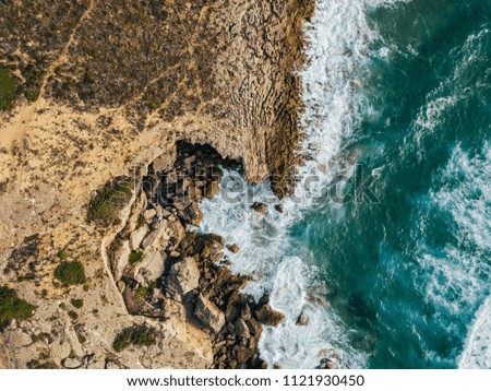 Similar – Aerial Drone View Of Dramatic Ocean Waves Crushing On Rocky Landscape