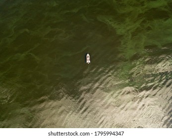 Aerial Drone View. Fishing Boat On The Water. Algae Bloom In The Water, Clouds Are Reflected.