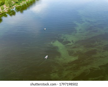 Aerial Drone View. Fishing Boat On The Water. Algae Bloom In The Water, Clouds Are Reflected.