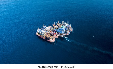 Aerial drone view of fishing trawlers in the ocean in asia - Shutterstock ID 1155376231