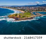 Aerial drone view of Flagstaff Point Lighthouse at Wollongong on the New South Wales South Coast, Australia with Wollongong city in the back ground on a sunny day   