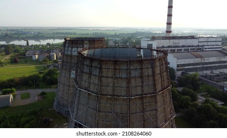 Aerial drone view flight near thermal power plant. Cooling towers of CHP thermoelectric power station. View of the power plant and cooling towers. Cooling towers of a thermoelectric power station
