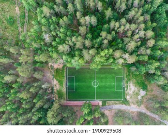 Aerial Drone View Of Football Soccer Pitch Field, Green Grass Summer Vibrant Pitch Playground In The Forest, Hidden In The Woods