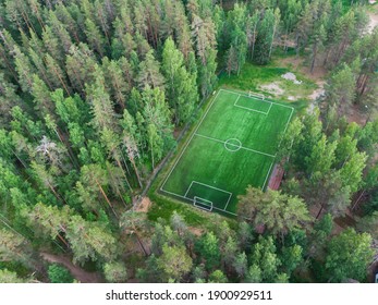 Aerial Drone View Of Football Soccer Pitch Field, Green Grass Summer Vibrant Pitch Playground In The Forest, Hidden In The Woods