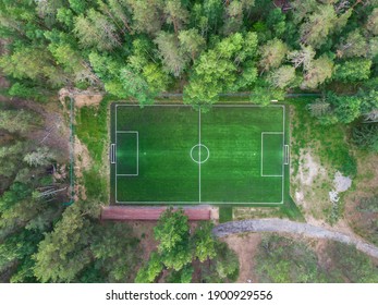 Aerial Drone View Of Football Soccer Pitch Field, Green Grass Summer Vibrant Pitch Playground In The Forest, Hidden In The Woods