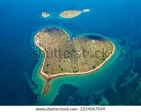 Aerial drone view of Galesnjak the Island of Love in Croatia with beautiful blue turquoise sea water. Heart shaped Island. Travel and holidays destination. Amazing tourism in Croatia Islands.