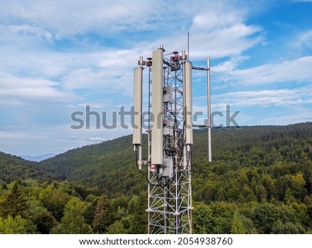 Aerial drone view of GSM and radio telecommunication tower in mountains. Cell phone tower. Base transceiver station. Wireless communication antenna transmitter.  