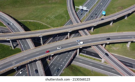 Aerial drone view of an interchange or a grade-separated junction is a road infrastructure that uses grade separations to allow for the movement of traffic between two or more roadways