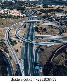 Aerial drone view of a large highway freeway interescting junction with on ramps and off ramps - captured in Cascais, Portugal