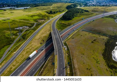 Aerial Drone View Of A Large, New Dual Carriageway Road With Motion Blurred Vehicles (A465, Wales, UK)